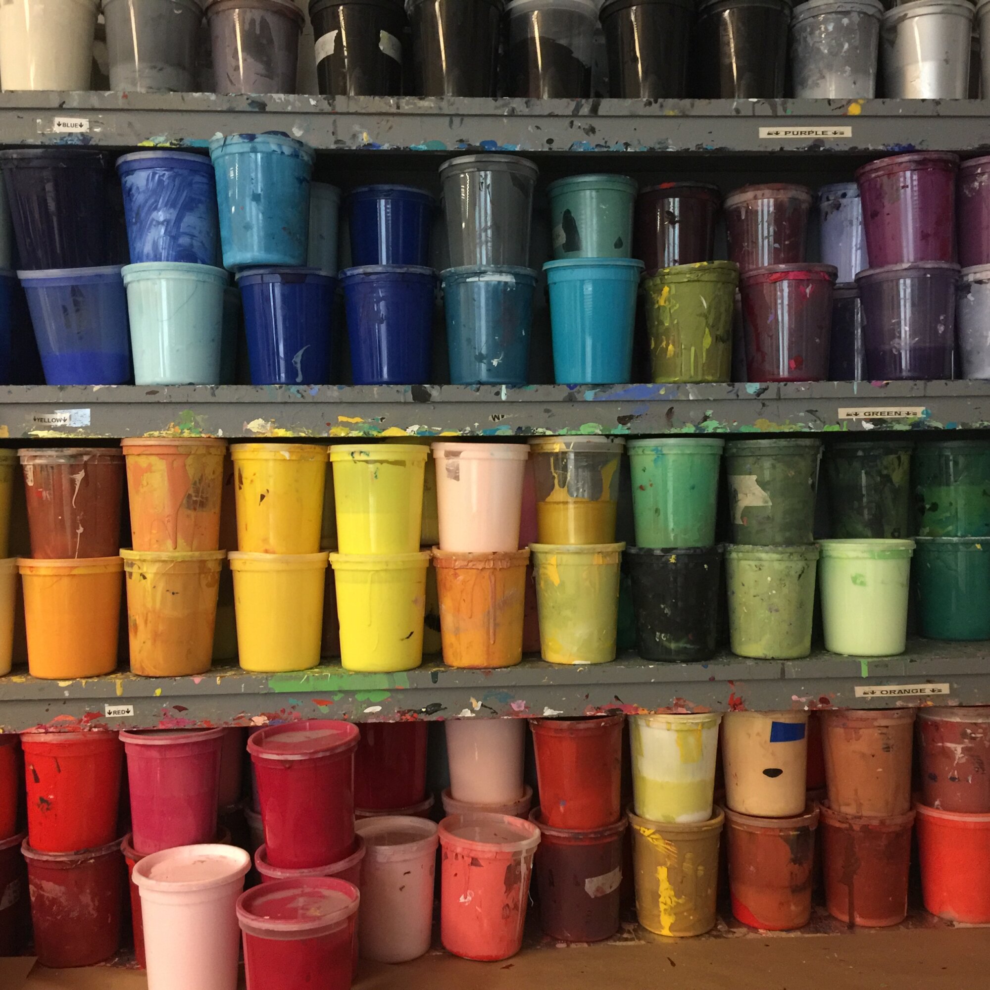 Jars of paint with a diversity of colors.